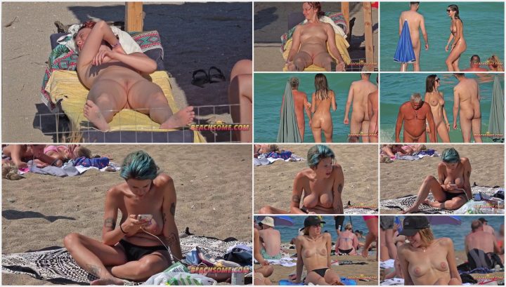 Two out of three friends enjoy topless on beach