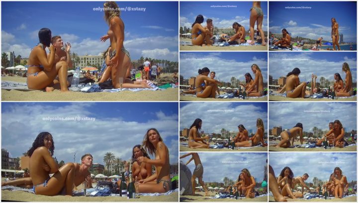 Two out of three friends enjoy topless on beach